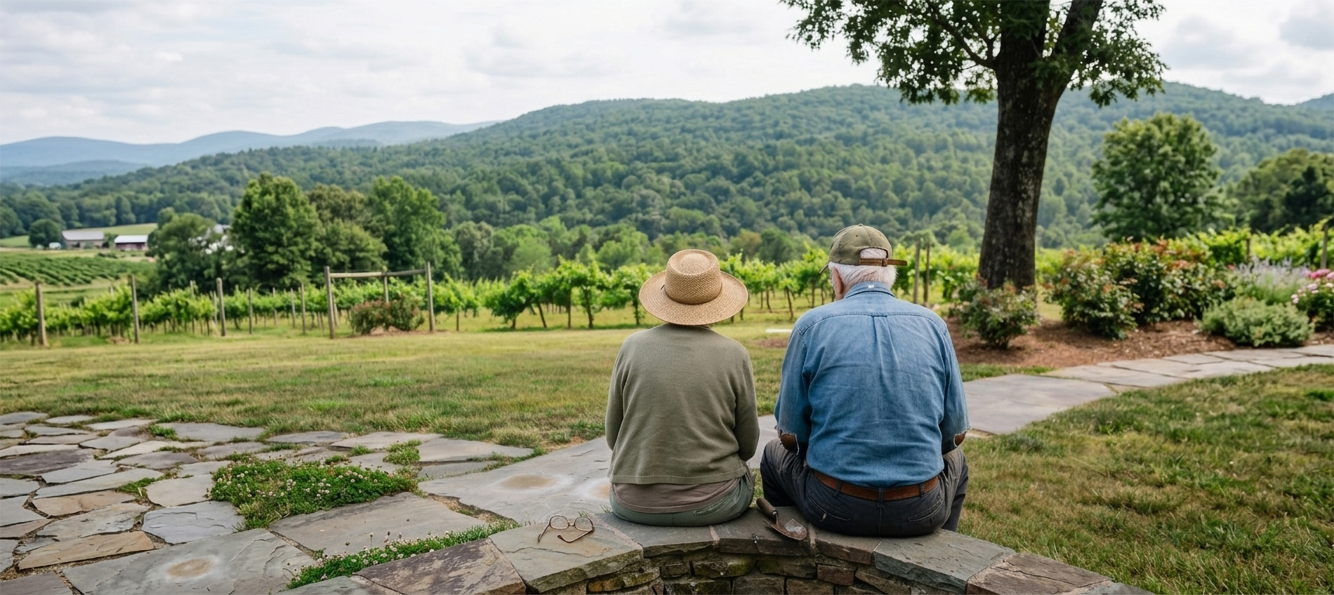 Two elderly people sitting together outdoors